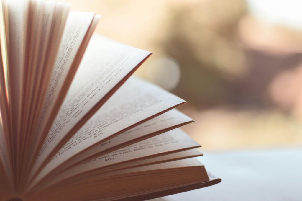 Free stock photo of a book resting on a wooden surface, splayed open in a way to invoke an inspirational or warm and fuzzy feeling